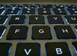 Backlit laptop keyboard, illustrating how to make an AI model for beginners