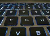 how to train an ai assistant in javascript, pictured as a backlit laptop keyboard
